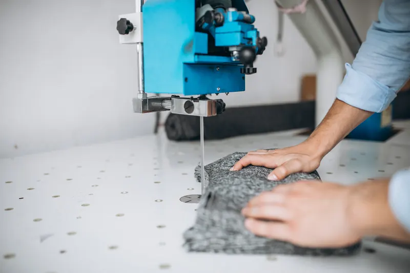 Fabric being cut on a cutting table in a sewing factory
